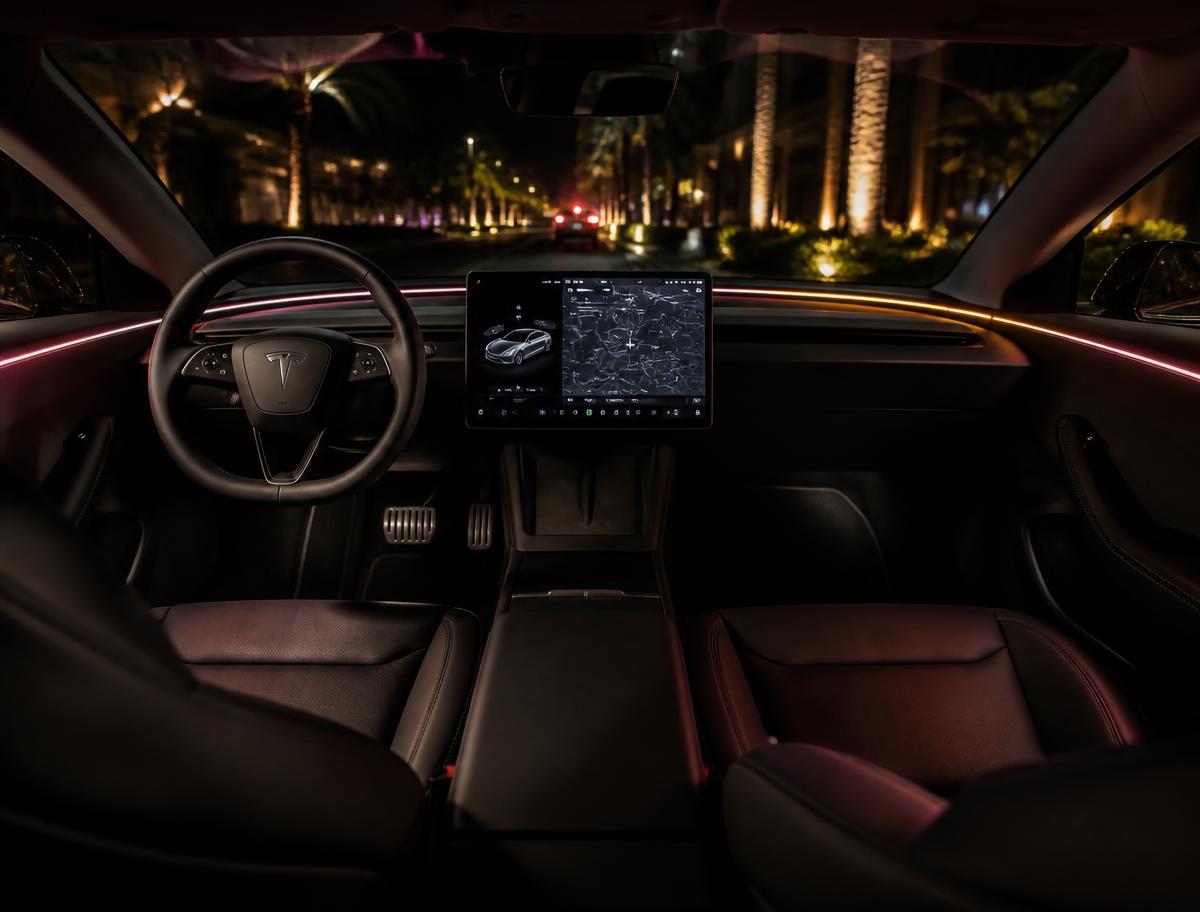 Black leather interior of a Tesla Model 3 at night